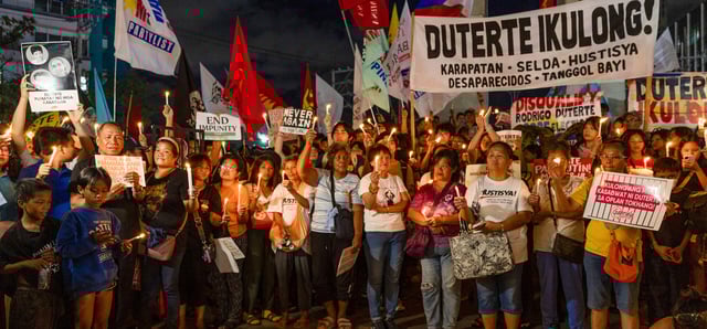 Protesters demonstrate during a candle light vigil demanding justice for drug war victims, after the arrest of former Philippine president Rodrigo Duterte, in Quezon City on March 11, 2025. (Photo by Earvin Perias / AFP) (Photo by EARVIN PERIAS/AFP via Getty Images)
