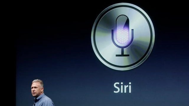 Apple’s Phil Schiller talks about Siri with the new Apple iPhone 4S during an announcement at Apple headquarters in Cupertino, Calif., Tuesday, Oct. 4, 2011. (AP Photo/Paul Sakuma)