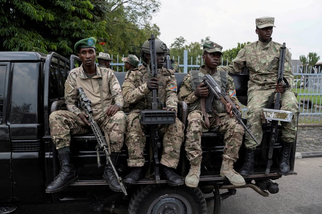 M23 rebels sit on a truck during the escort of captured FDLR members (not pictured) to Rwanda for repatriation, at the Goma-Gisenyi Grande Barrier border crossing, March 1, 2025. REUTERS/Arlette Bashizi/File Photo