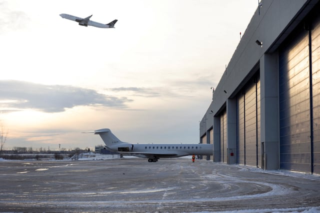 A worker stands as a Bombardier Global 7500 aircraft is moved onto the tarmac outside their private jet completion center in Montreal, Quebec, Canada February 6, 2025. REUTERS/Evan Buhler/File Photo