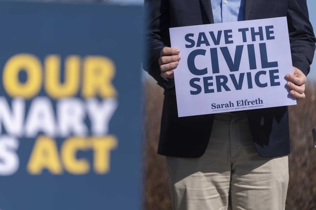 A fired federal probationary worker holds a sign reading &#34;Save the Civil Service&#34; at a news conference about the Protect Our Probationary Employees Act on Capitol Hill on March 11, 2025, in Washington. 