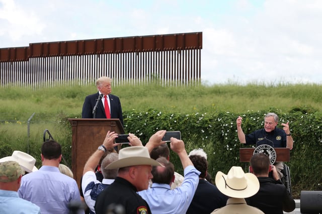Texas Gov. Greg Abbott, right, and former President Donald Trump address supporters and media by the border wall in Pharr, Texas, Wednesday, June 30, 2021.
