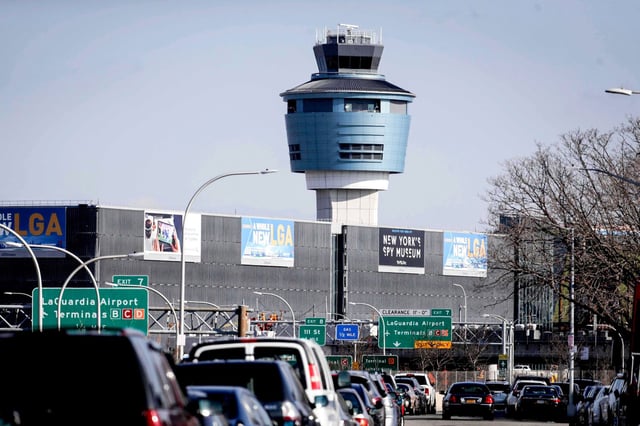 Traffic moves past the air traffic control tower at LaGuardia Airport in Queens, N.Y., on Jan. 25, 2019.