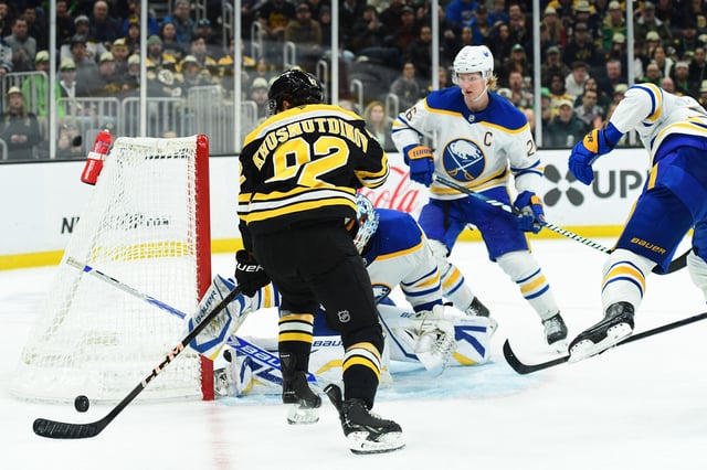 Mar 17, 2025; Boston, Massachusetts, USA;  Boston Bruins center Marat Khusnutdinov (92) battles for the puck in front of Buffalo Sabres goaltender Ukko-Pekka Luukkonen (1) during the third period at TD Garden. Mandatory Credit: Bob DeChiara-Imagn Images