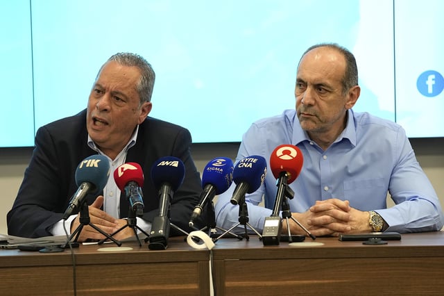 Cyprus' defense minister Vasilis Palmas, left, and minister of Justice and Public Order Marios Hartsiotis talk to the media at a coordination center in Larnaca, Cyprus, on Monday, March 17, 2025 after a migrant shipwreck off Cyprus' coast leaves 7 dead and 2 survivors. (AP Photo/Petros Karadjias)