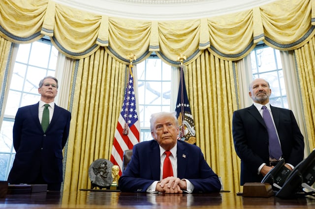 US Secretary of Treasury Scott Bessent, left, and Howard Lutnick, right, stand behind President Donald Trump as he speaks to reporters in the Oval Office of the White House on February 3, in Washington, DC.
