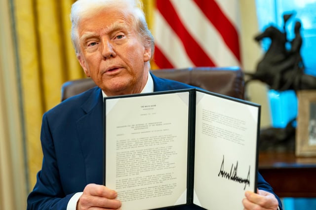 President Donald Trump signs executive orders in the Oval Office of the White House, on Jan. 30, 2025.