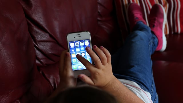 MPs heard young children are suffering from back problems normally seen in middle-aged people because of phone use (Peter Byrne/PA)
