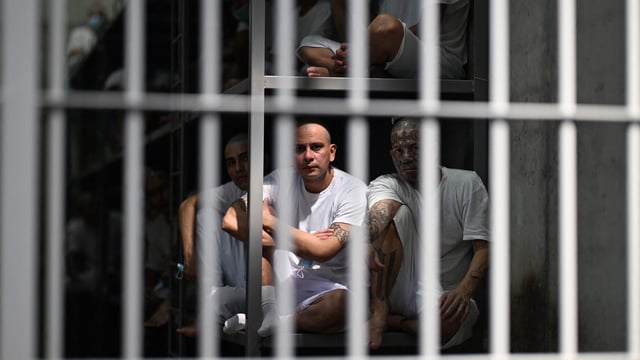 Inmates look on as they remain in a cell at the Counter-Terrorism Confinement Centre (CECOT) mega-prison.
