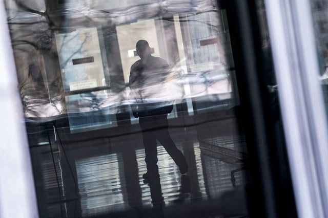 A security guard passes through the lobby of the U.S. Department of Education headquarters after the agency said it would lay off nearly half its staff, a possible precursor to closing altogether, as government agencies scrambled to meet President Donald Trump's deadline to submit plans for a second round of mass layoffs, in Washington, D.C., U.S., March 12, 2025. REUTERS/Nathan Howard/File Photo