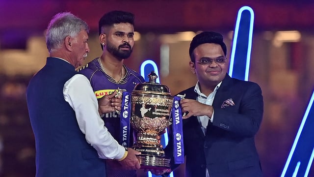 Roger Binny (L), president of the Board of Control for Cricket in India (BCCI) along with Jay Shah (R), secretary of the BCCI, presents the IPL trophy to Kolkata Knight Riders' captain Shreyas Iyer 