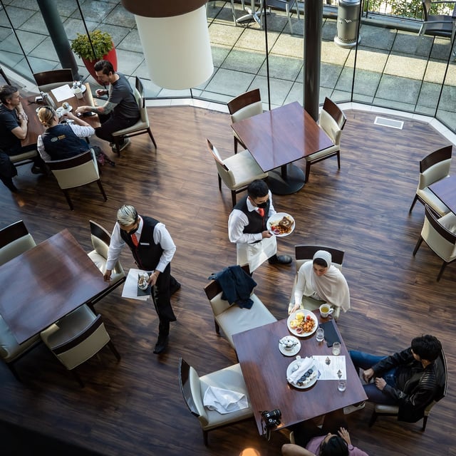 A server brings food to a table as people dine at a restaurant in Vancouver, on Tuesday, September 21, 2021. Tipping fatigue is hitting consumers as requests for gratuities increase and spread to new businesses amid the rise of automated payment machines and preset tip suggestions.THE CANADIAN PRESS/Darryl Dyck