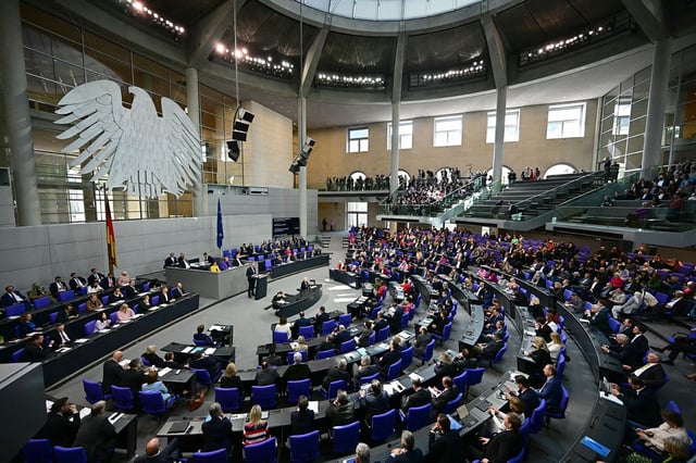 Friedrich Merz (C-L), leader of Germany's Christian Democratic Union (CDU), speaks during a session of the Bundestag (lower house of parliament) on March 18, 2025 in Berlin, Germany. German lawmakers will vote on a massive spending boost for defence and infrastructure proposed by chancellor-in-waiting Friedrich Merz amid concern over the United States' commitment to Europe's security. The hastily drawn plans represent a radical departure for a country traditionally reluctant to take on large amounts of debt or to spend heavily on the military, given the horrors of its Nazi past. (Photo by Tobias SCHWARZ / AFP) (Photo by TOBIAS SCHWARZ/AFP via Getty Images)          