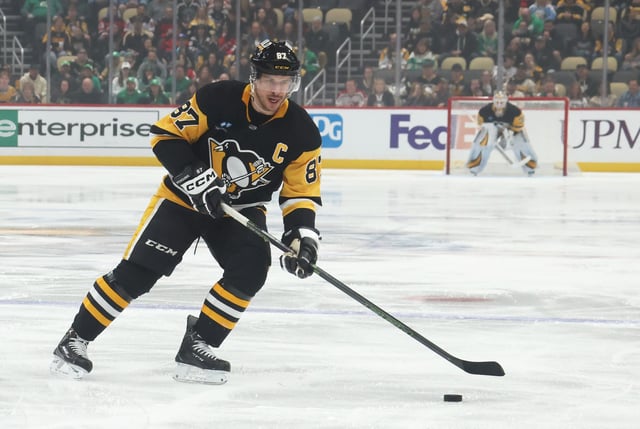 Mar 15, 2025; Pittsburgh, Pennsylvania, USA;  Pittsburgh Penguins center Sidney Crosby (87) moves the puck against the New Jersey Devils during the first period at PPG Paints Arena. Mandatory Credit: Charles LeClaire-Imagn Images/File Photo