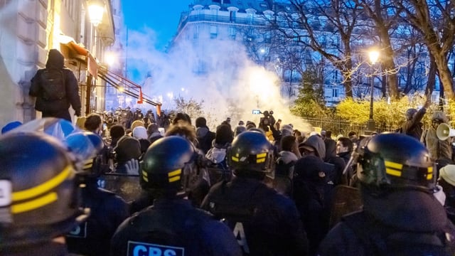 Police use tear gas on protesters who had gathered outside the Gaïté Lyrique theatre in support of the migrants being evicted