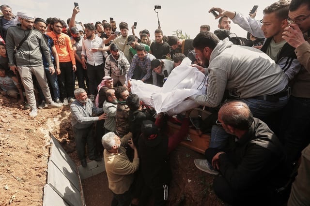 The body of Muhannad Akrad, one of three people killed in Israeli airstrikes on Monday, is laid to rest in Daraa, southern Syria, Tuesday, March 18, 2025. (AP Photo/Omar Sanadiki)