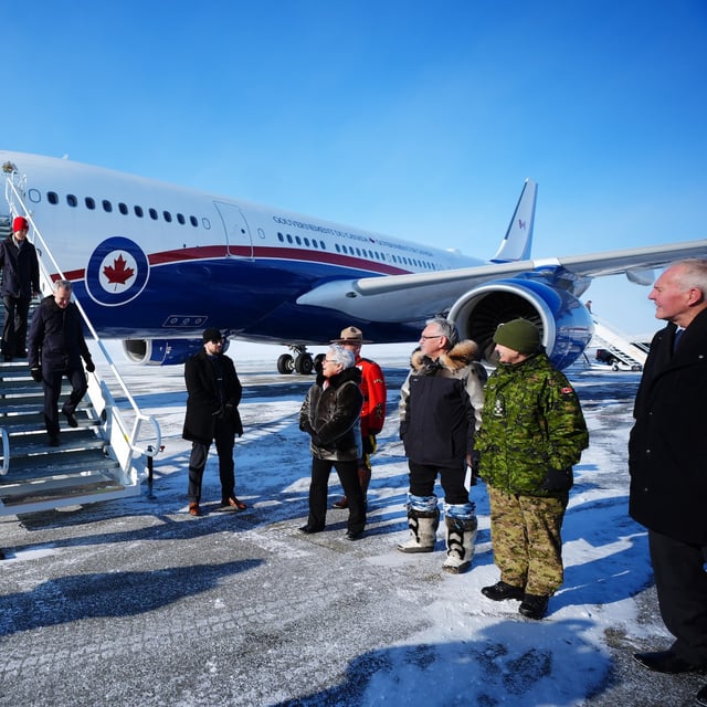 Prime Minister Mark Carney and his wife Diana Fox Carney are greeted by Commissioner of Nunavut Eva Aariak, Deputy Mayor Harry Flaherty, Chief of Defense Staff Gen. Jennie Carignan and Defence Minister Bill Blair as they arrive in Iqaluit, Nunavut, on Tuesday, March 18, 2025. THE CANADIAN PRESS/Sean Kilpatrick