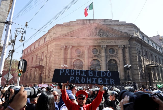 A demonstrator in support of bullfighting holds a sign reading 'Prohibited to prohibit' outside the Congress of Mexico City, in Mexico City, Mexico March 18, 2025. REUTERS/Raquel Cunha