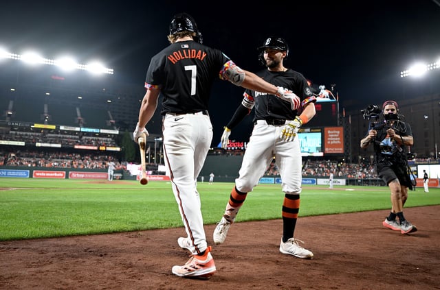 Coby Mayo (R) #16 of the Baltimore Orioles celebrates with Jackson Holliday #7 after hitting a home run in the second inning against the Detroit Tigers at Oriole Park at Camden Yards on September 20, 2024 in Baltimore, Maryland.