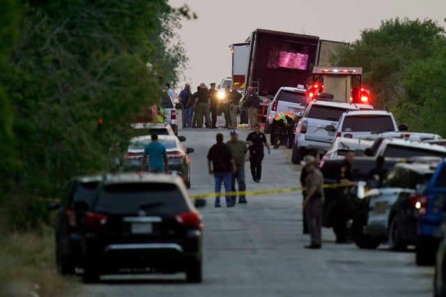 Police and other first responders work the scene where officials say dozens of people have been found dead and multiple others were taken to hospitals with heat-related illnesses after a tractor-trailer containing suspected migrants was found on June 27, 2022, in San Antonio.
