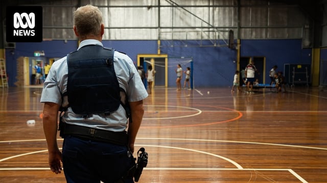 A Moree police officer playing goaltender at the PCYC hall