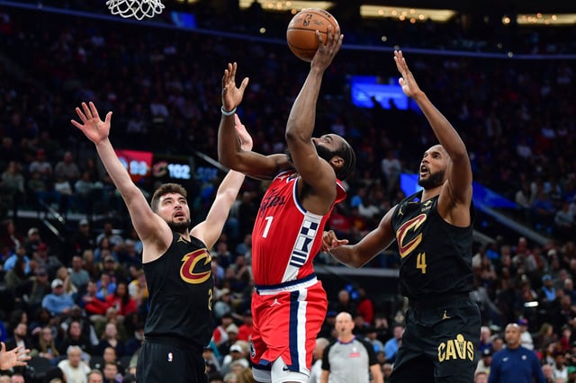 Mar 18, 2025; Inglewood, California, USA; Los Angeles Clippers guard James Harden (1) shoots against Cleveland Cavaliers guard Ty Jerome (2) and forward Evan Mobley (4) during the second half at Intuit Dome. Mandatory Credit: Gary A. Vasquez-Imagn Images