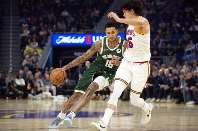 Mar 18, 2025; San Francisco, California, USA; Milwaukee Bucks forward Kyle Kuzma (18) drives around Golden State Warriors forward Gui Santos (15) during the first quarter at Chase Center. Mandatory Credit: D. Ross Cameron-Imagn Images