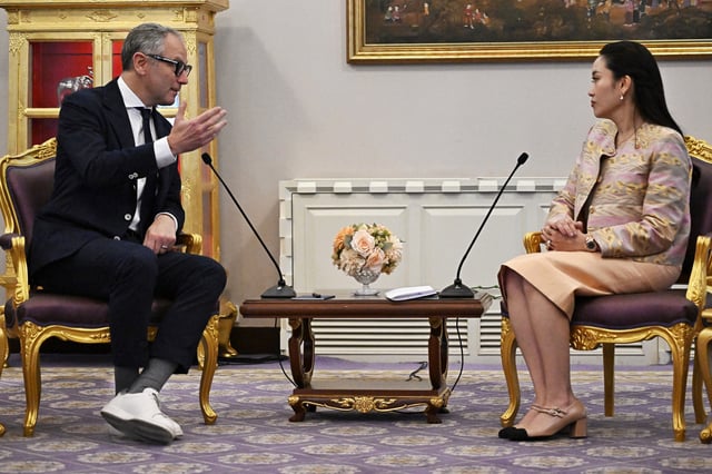Formula One CEO Stefano Domenicali (L) speaks to Thailand&#39;s Prime Minister Paetongtarn Shinawatra (R) during a meeting at the Government House in Bangkok on March 18, 2025. Stefano Domenicali held talks with Thailand&#39;s prime minister about possible plans to bring a grand prix to the kingdom.