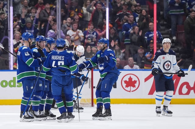 Vancouver Canucks' Elias Pettersson, from left to right, Brock Boeser, Jonathan Lekkerimaki, Elias Pettersson and Jake DeBrusk celebrate Boeser's goal as Winnipeg Jets' Vladislav Namestnikov, back right, skates to the bench during first period NHL hockey action in Vancouver, B.C., Tuesday, March 18, 2025. THE CANADIAN PRESS/Darryl Dyck