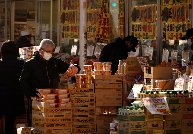 Shoppers check foods at a supermarket in Tokyo, Japan January 10, 2023. REUTERS/Issei Kato/File Photo