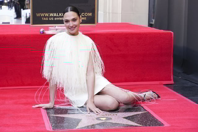 Gal Gadot poses with her new star at a ceremony honoring her on the Hollywood Walk of Fame on Tuesday, March 18, 2025, in Los Angeles.