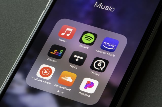 Portland, OR, USA - Mar 15, 2021: Assorted music streaming apps, including Apple Music, Spotify, Amazon Music, Deezer, TIDAL, Qobuz, YouTube Music, SoundCloud, and Pandora, are seen on an iPhone.