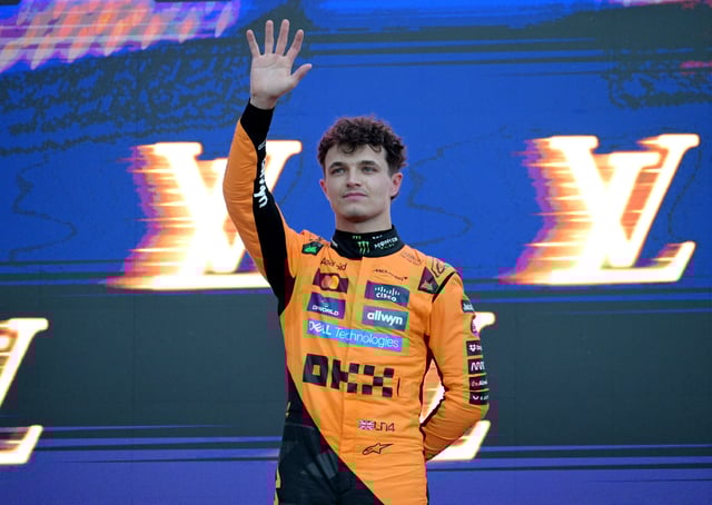Formula One F1 - Australian Grand Prix - Albert Park Grand Prix Circuit, Melbourne, Australia - March 16, 2025 McLaren's Lando Norris celebrates with the trophy on the podium after winning the Australian Grand Prix along with second placed Red Bull's Max Verstappen and third placed Mercedes' George Russell REUTERS/Tracey Nearmy/File Photo