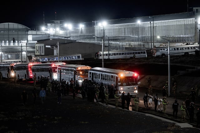 Salvadoran police officers escort alleged members of the Venezuelan gang Tren de Aragua recently deported by the U.S. government to be imprisoned in the Terrorism Confinement Center (CECOT) prison, as part of an agreement with the Salvadoran government, in Tecoluca, El Salvador, in this handout image obtained March 16, 2025. Secretaria de Prensa de la Presidencia/Handout via REUTERS/File Photo