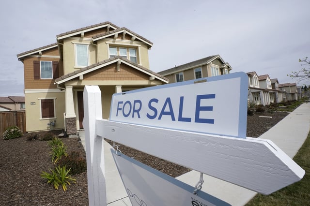 A &#34;for sale&#34; sign is posted in front of a home in Sacramento, Calif., March 3, 2022.