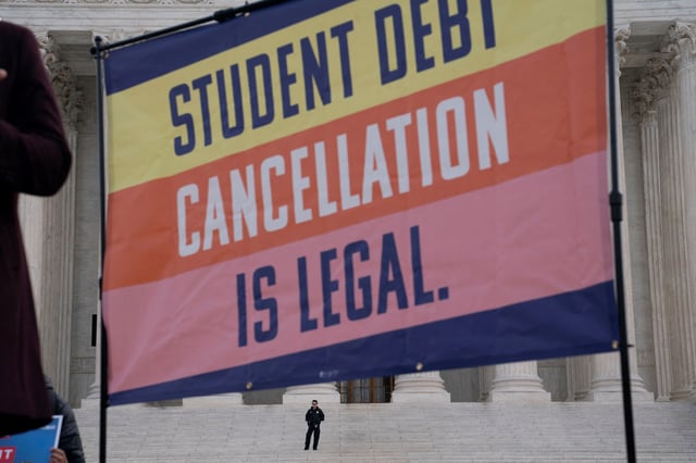 A law enforcement officer watches as supporters of student loan debt relief rally in front of the Supreme Court as the justices are scheduled to hear oral arguments in two cases involving President Joe Biden's bid to reinstate his plan to cancel billions of dollars in student debt in Washington, U.S., February 28, 2023.