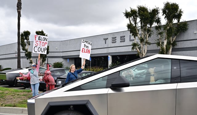 People participate in a &#34;TeslaTakedown&#34; protest against Elon Musk outside of a Tesla dealership in Irvine, California, March 1, 2025.
