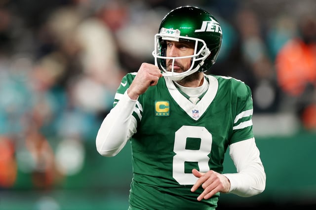 Aaron Rodgers #8 of the New York Jets reacts after a touchdown against the Miami Dolphins during the fourth quarter at MetLife Stadium on January 05, 2025