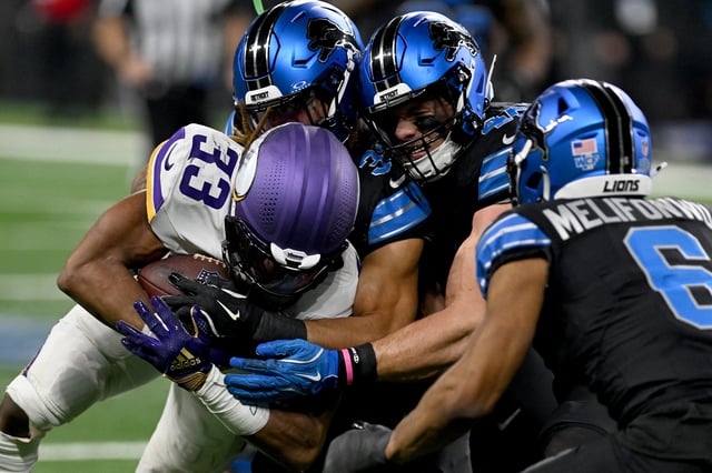 Jan 5, 2025; Detroit, Michigan, USA; Minnesota Vikings running back Aaron Jones (33) is tackled by Detroit Lions safety Kerby Joseph (31) linebacker Jack Campbell (46) and safety Ifeatu Melifonwu (6) on a third quarter run at Ford Field. Mandatory Credit: Lon Horwedel-Imagn Images/File Photo