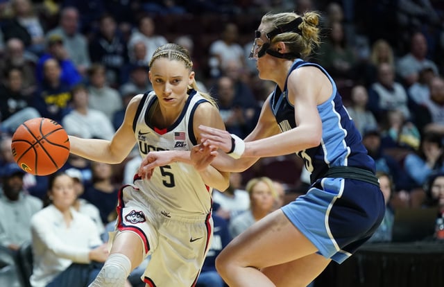Mar 9, 2025; Uncasville, CT, USA; UConn Huskies guard Paige Bueckers (5) drives the ball against Villanova Wildcats guard Maddie Burke (23) in the first half at Mohegan Sun Arena. Mandatory Credit: David Butler II-Imagn Images/File Photo