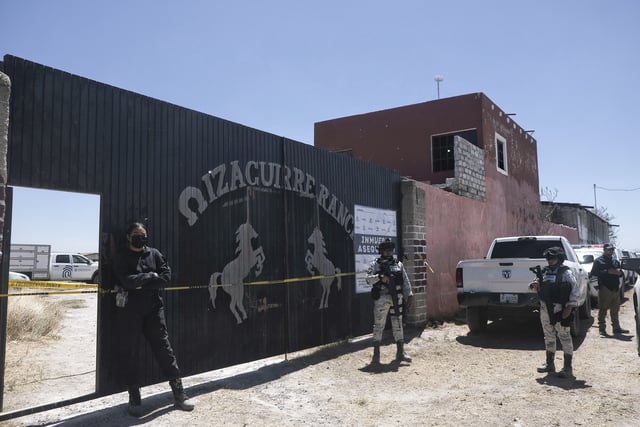 Police stand guard outside the entrance to Izaguirre Ranch where skeletal remains were discovered in Teuchitlan, Jalisco state, Mexico, Thursday, March 13, 2025. (AP Photo/Alejandra Leyva)