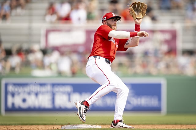 FORT MYERS, FLORIDA - MARCH 15: Trevor Story #10 of the Boston Red Sox attempts to make a play at second base against the Atlanta Braves at JetBlue Park at Fenway South in Fort Myers, Florida on March 15, 2025.