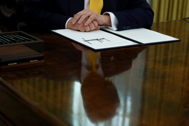 U.S. President Donald Trump places his hands on a signed executive order in the Oval Office of the White House in Washington, D.C., U.S., March 7, 2025. REUTERS/Evelyn Hockstein/File Photo
