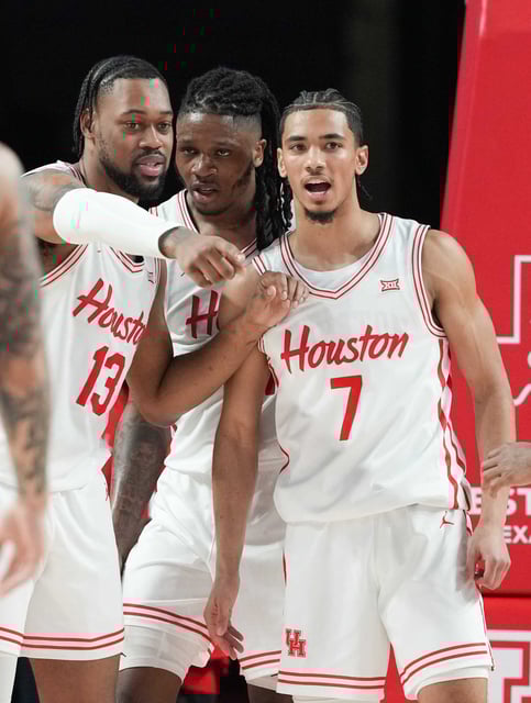 Spending time with UH mainstay J&#39;Wan Roberts (13) was a notable part of Milos Uzan&#39;s visit to campus before deciding to transfer..