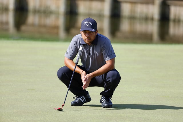 Mar 14, 2025; Ponte Vedra Beach, Florida, USA; Xander Schauffele eyes his putt on the eighteenth green during the second round of The Players Championship golf tournament at TPC Sawgrass. Mandatory Credit: Jeff Swinger-Imagn Images/File Photo