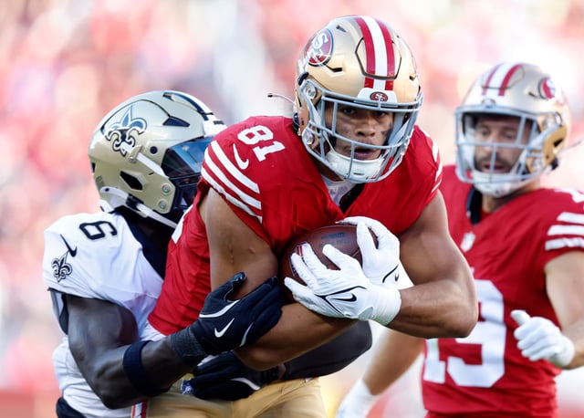 San Francisco 49ers&#39; Cameron Latu (81) runs after a catch against New Orleans Saints&#39; Willie Gay Jr. (6) in the second quarter of their preseason game at Levi&#39;s Stadium in Santa Clara, Calif., on Sunday, Aug. 18, 2024. (Nhat V. Meyer/Bay Area News Group)