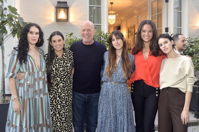 Bruce Willis poses with his wife, Emma Heming Willis. ex-wife Demi Moore and his and Moore's three daughters, Rumer Willis, Scout Willis and Tallulah Willis in September 2019.