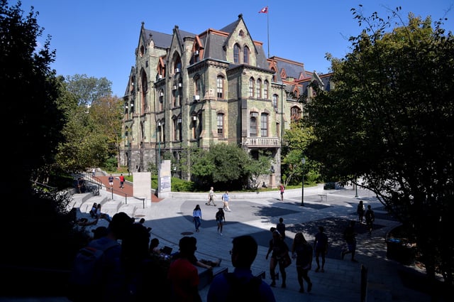 Students walk between classes in front of College Hall on the campus of the University of Pennsylvania in Philadelphia, Pennsylvania, U.S., September 25, 2017. REUTERS/Charles Mostoller/File Photo