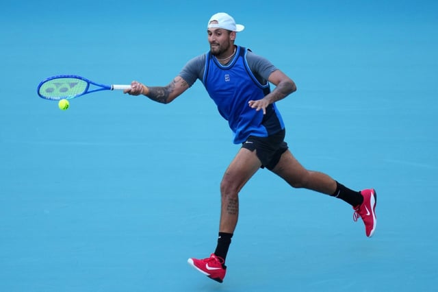 Nick Kyrgios returns a shot against Mackenzie McDonald en route to his first win since 2022