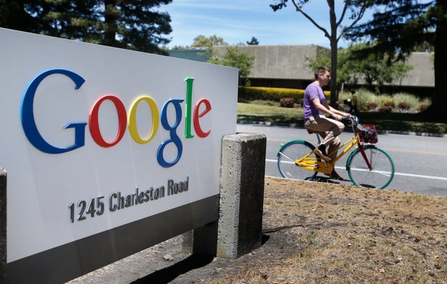 Google employees ride their Google multi-colored bicycles to and from the GooglePlex along Charleston Road in Mountain View, Tuesday, June 24, 2014. Large and small, buildings are being collected in Mountain View by Google, which is on a shopping spree for parcels near — and sometimes not so near — its headquarters in Mountain View. (Patrick Tehan/Bay Area News Group)
